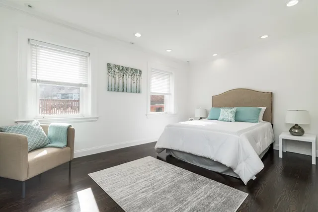 a view of a room with furniture and wooden floor