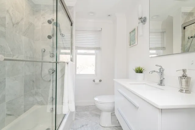 a kitchen with stainless steel appliances granite countertop a stove and white cabinets