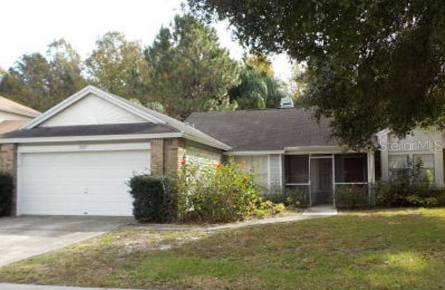 2312 Moon Shadow Road New Port Richey, FL 34655 - Photo 1 of 1 a front view of a house with a yard and garage