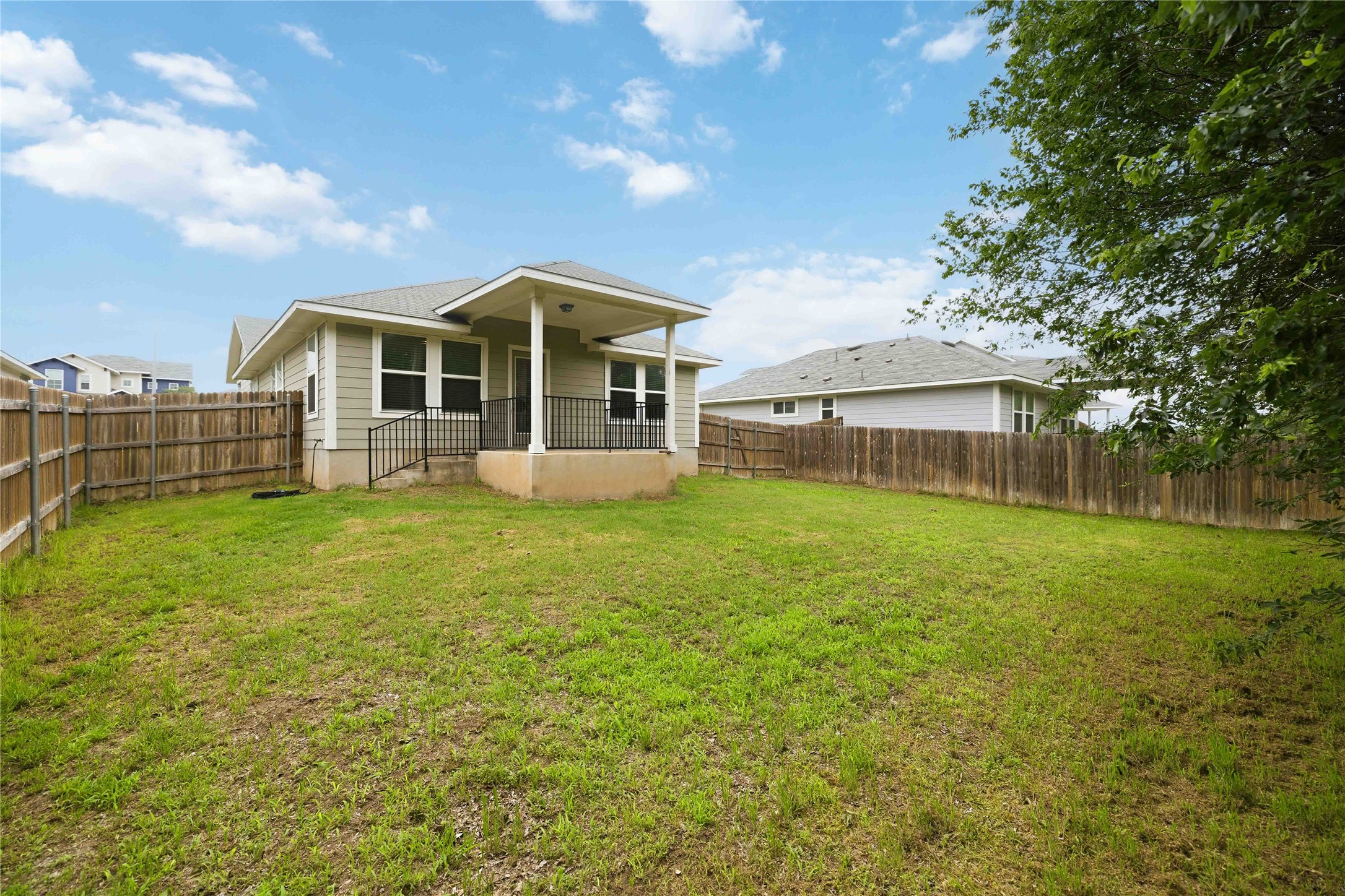 107 Saranac Drive Elgin, TX 78621 - Photo 16 of 17 a front view of a house with a garden and lake view