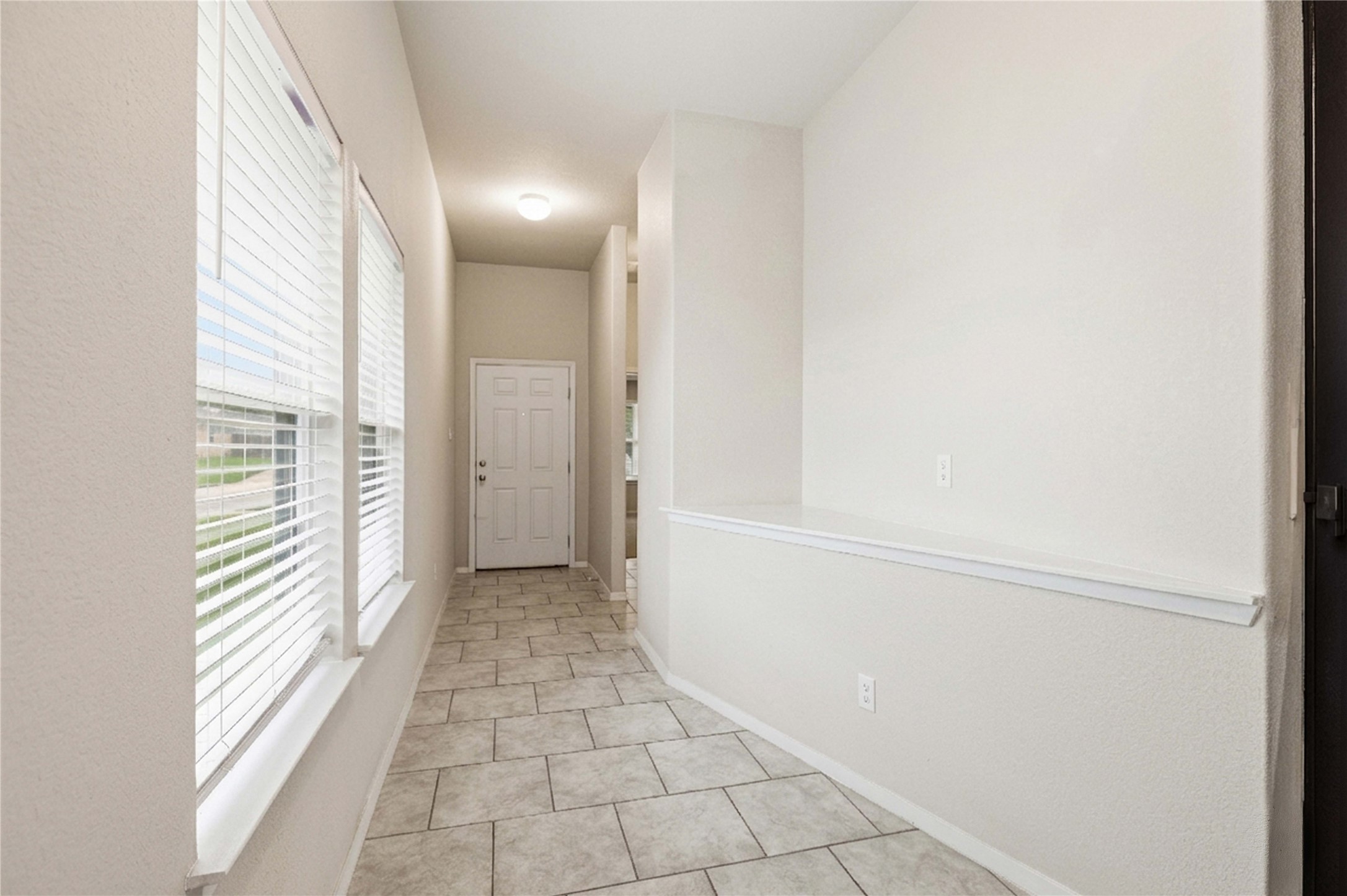107 Saranac Drive Elgin, TX 78621 - Photo 2 of 17 a view of a hallway with wooden floor and a bathroom