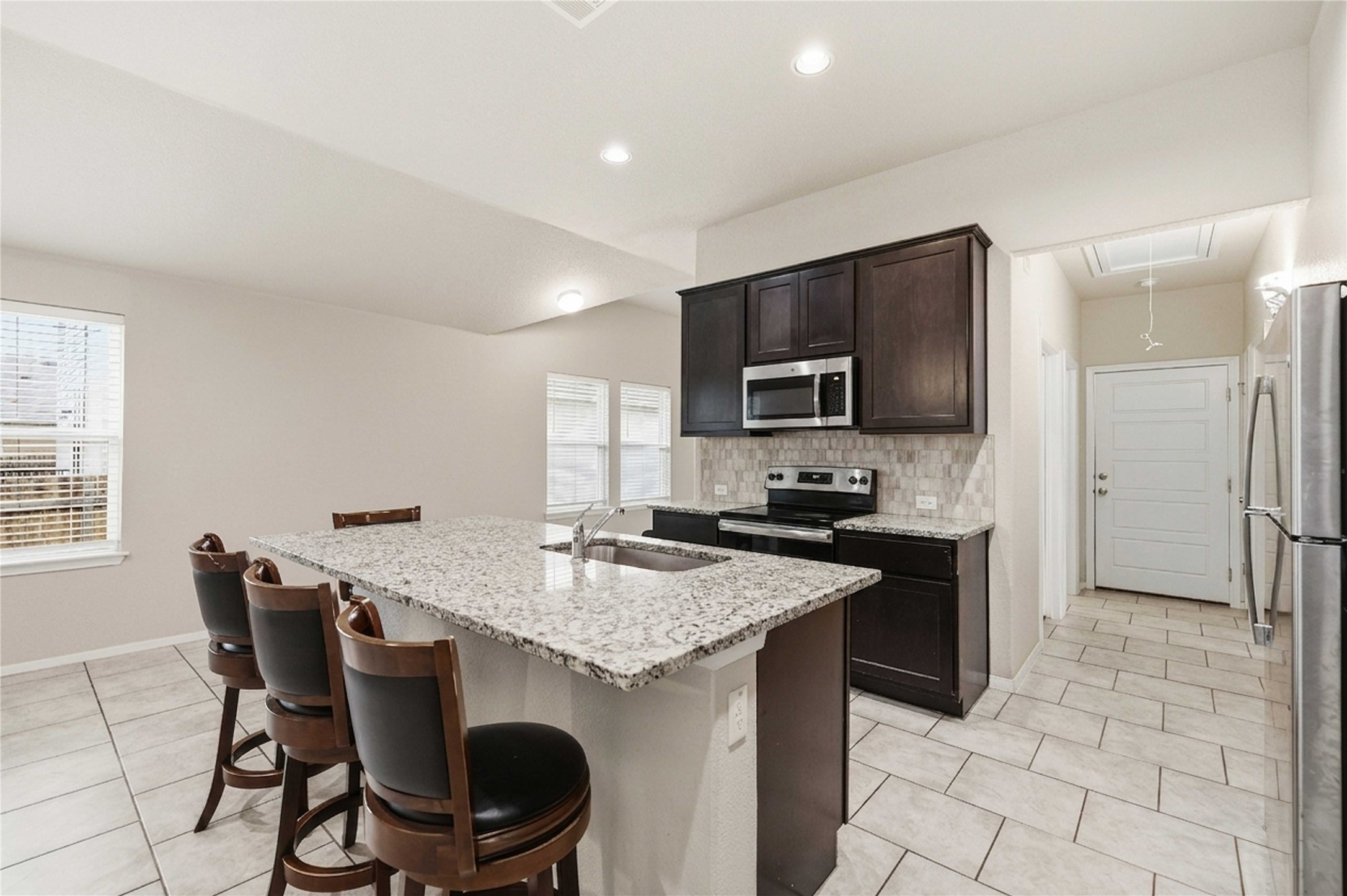 107 Saranac Drive Elgin, TX 78621 - Photo 6 of 17 a kitchen with granite countertop a sink appliances and cabinets