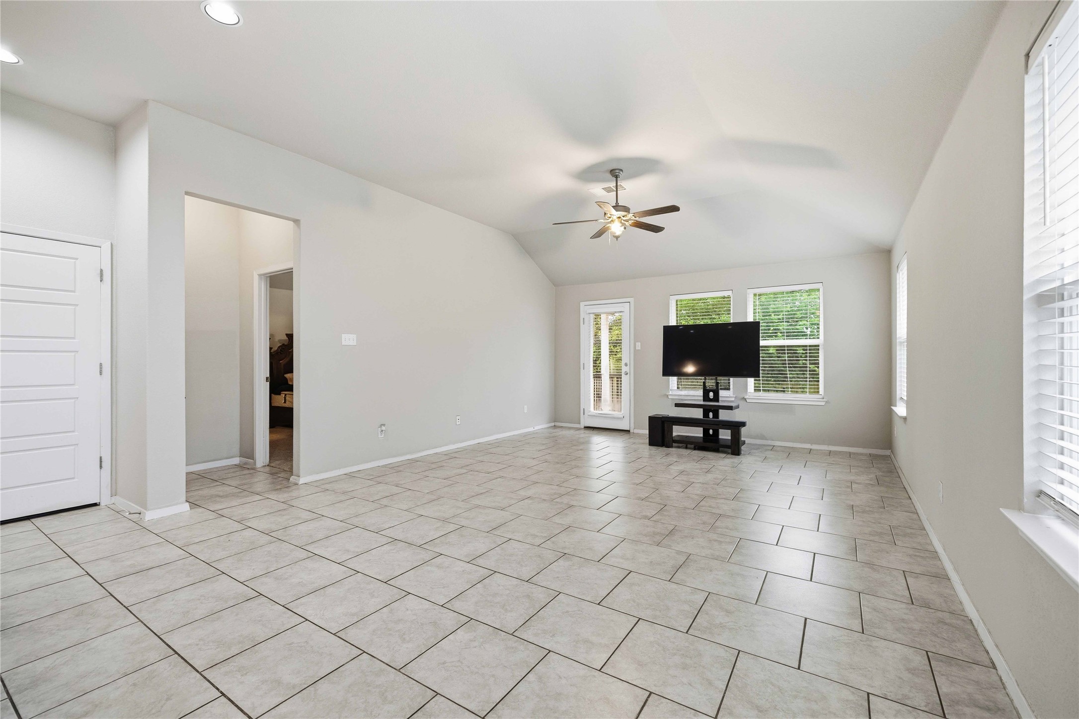 107 Saranac Drive Elgin, TX 78621 - Photo 7 of 17 an empty room with windows and view of bathroom