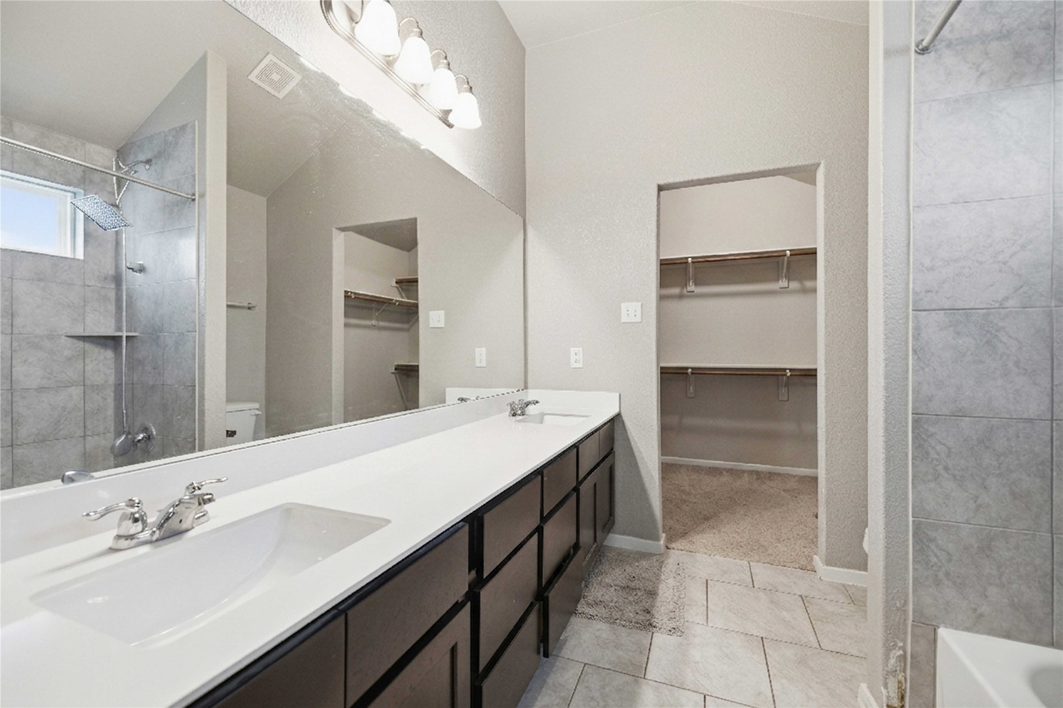 107 Saranac Drive Elgin, TX 78621 - Photo 10 of 17 a bathroom with a double vanity sink mirror and bathtub