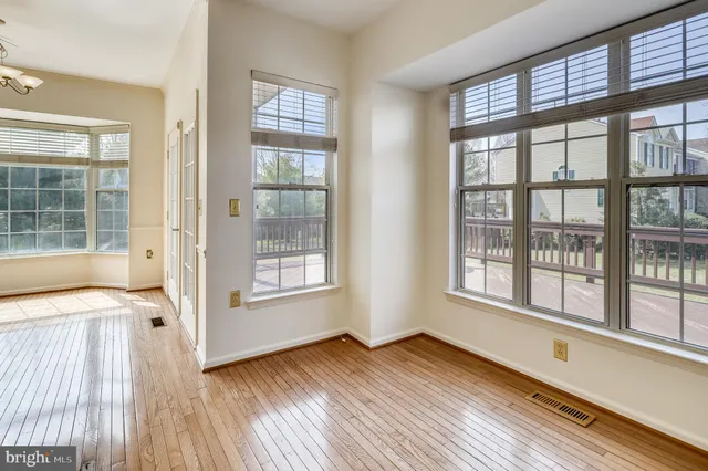 a view of a room with wooden floor and windows