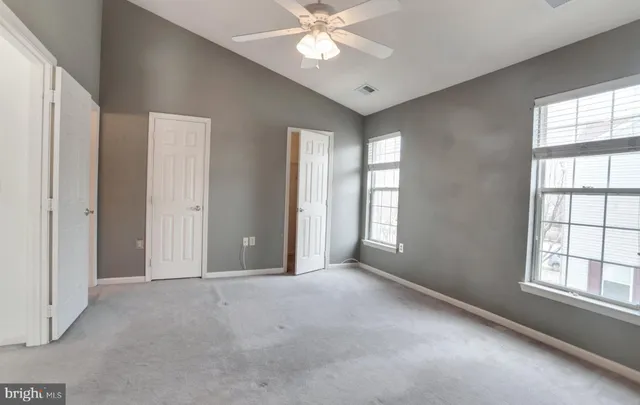 a view of a livingroom with a ceiling fan and window