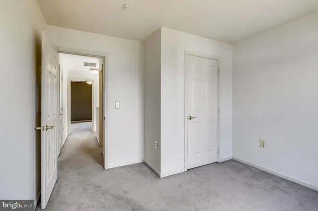 a view of an empty room and closet