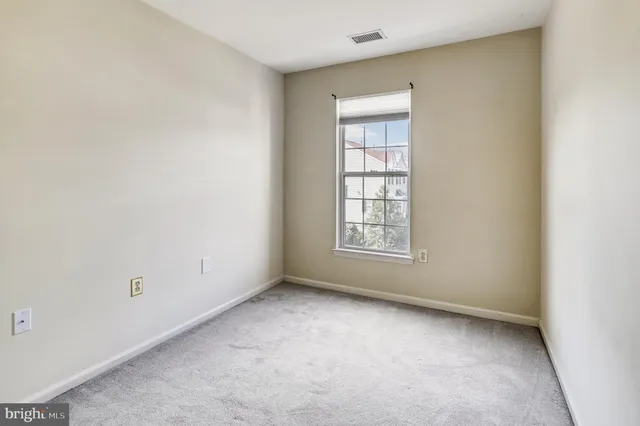 a view of an empty room with a fireplace