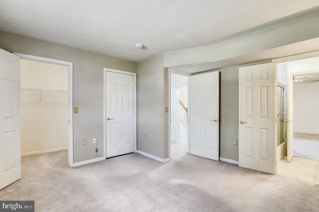 a view of an empty room and closet area