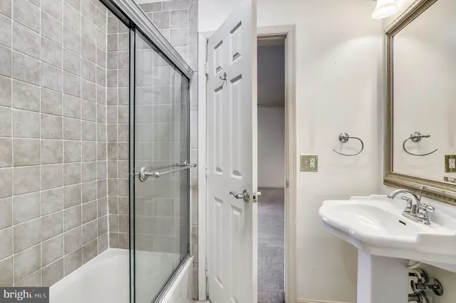a white toilet sitting next to a shower