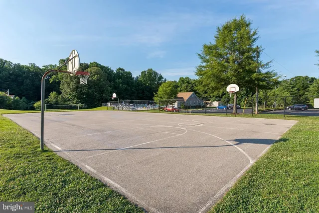 a view of a patio with a table and chairs under an umbrella