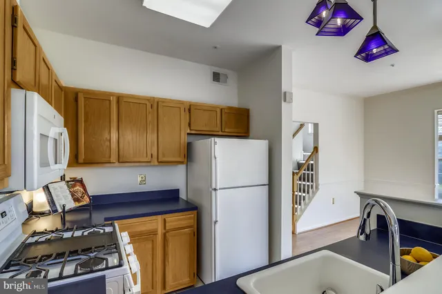 a kitchen with stainless steel appliances granite countertop a refrigerator and a stove