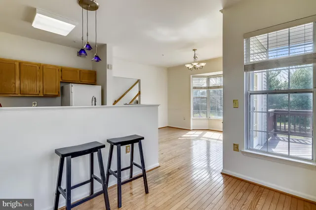 a very nice looking room with wooden floor and windows