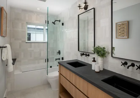 a bathroom with a granite countertop sink a toilet and shower