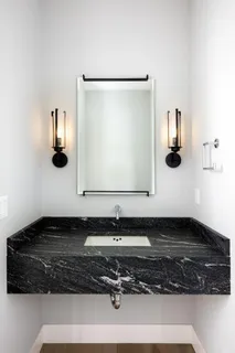 a bathroom with a sink and mirror
