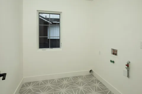 a view of an empty room with wooden floor and closet