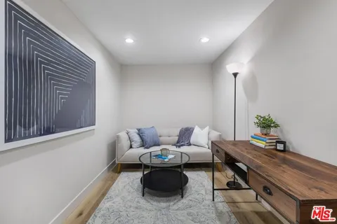 a living room with a table and chairs