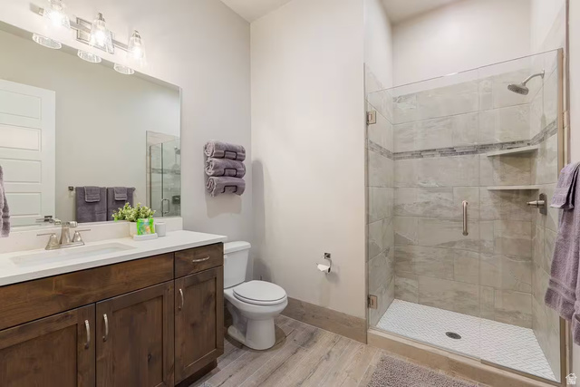 2600 Ocotillo Way, Unit 56 Santa Clara, UT 84765 - Photo 20 of 33 Bathroom featuring light wood-style flooring, vanity, and a stall shower