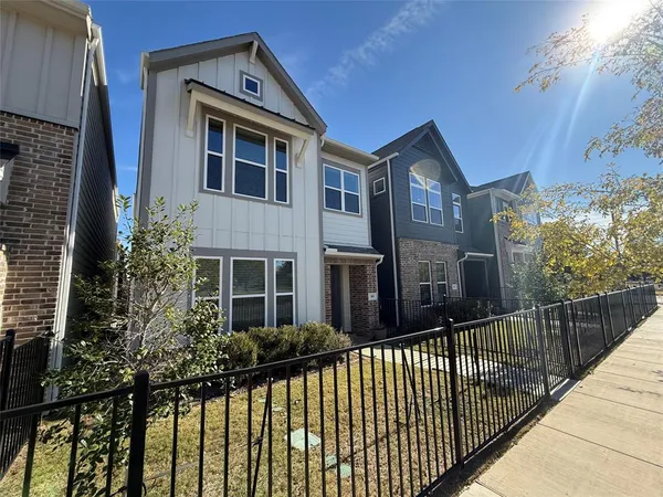 a view of a brick house with large windows