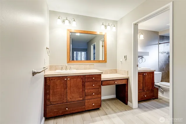 a bathroom with a double vanity sink and mirror