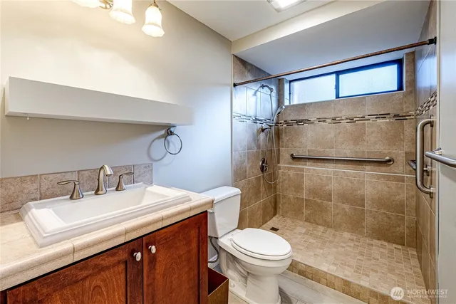 a bathroom with a sink toilet and shower