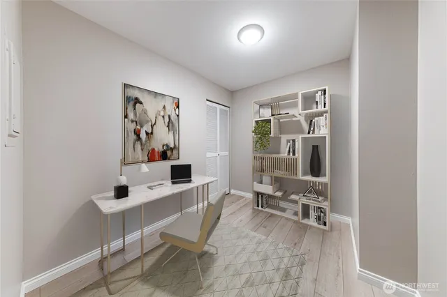 a view of a workspace with furniture and a window