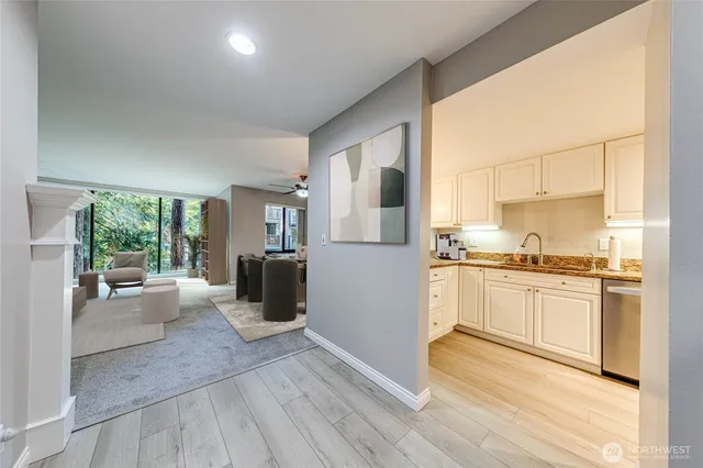 a kitchen with a refrigerator and wooden floor