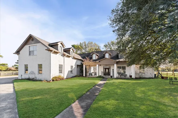 a front view of house with a garden