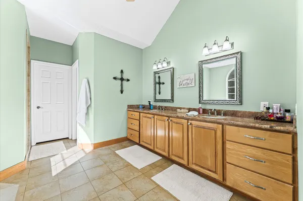 a spacious bathroom with a double vanity sink and a mirror