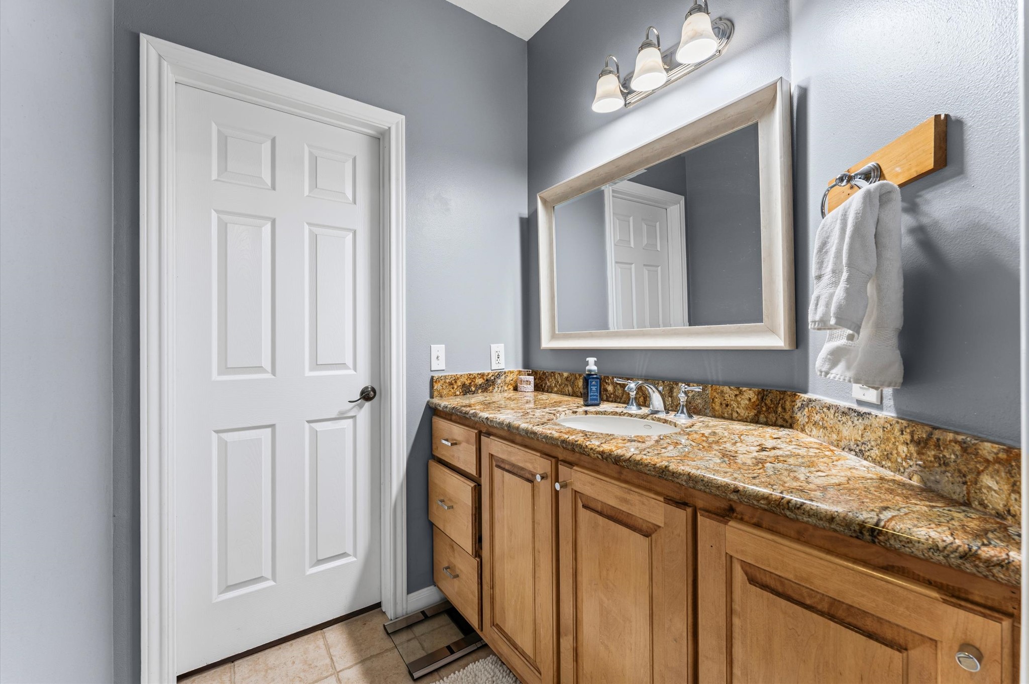 21550-21554 Mueschke Road Tomball, TX 77377 - Photo 17 of 42 a bathroom with a granite countertop sink and a mirror