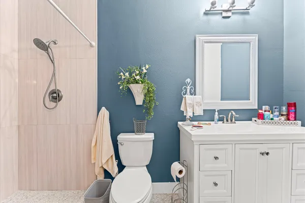 a bathroom with a sink mirror vanity and toilet