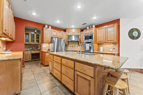 a kitchen with stainless steel appliances granite countertop a sink and cabinets