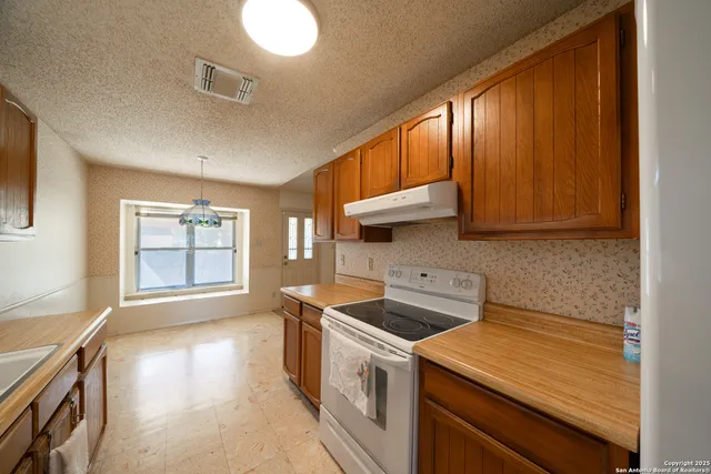 a kitchen that has a sink and a stove