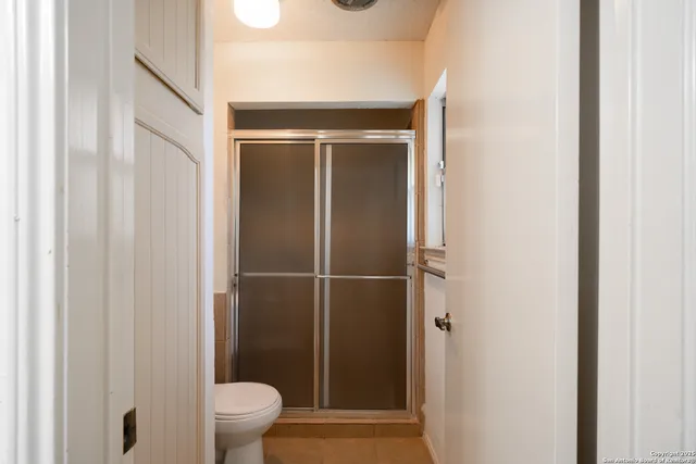 a bathroom with a shower and a toilet