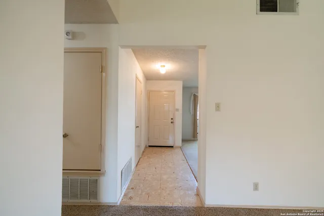 a view of a room with wooden floor and a sink