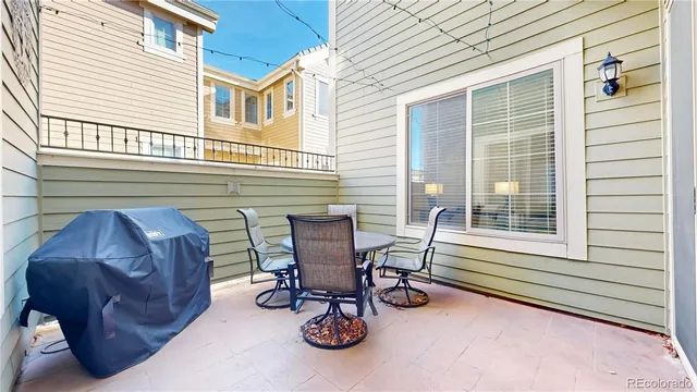 a view of patio with a table and chairs