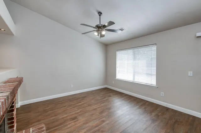 a view of a livingroom with a fireplace and wooden floor
