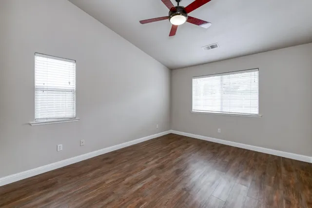 wooden floor in an empty room with a window