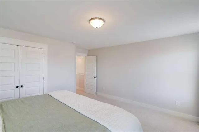 a bathroom with a double vanity sink toilet mirror and shower
