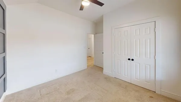 an empty room with closet area