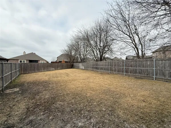 a view of a house with wooden fence