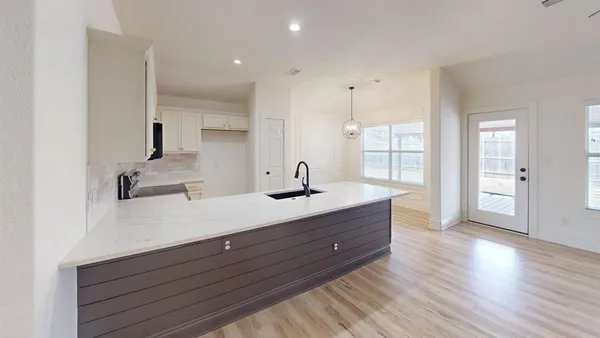 a spacious bathroom with double vanity and a mirror