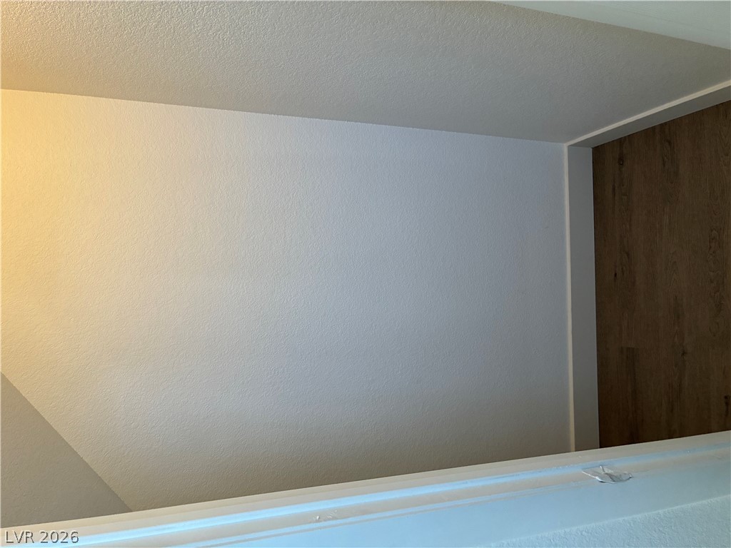 7727 Pista Way Las Vegas, NV 89179 - Photo 7 of 12 Clean lines and a luminous ceiling illuminate this minimal interior space.