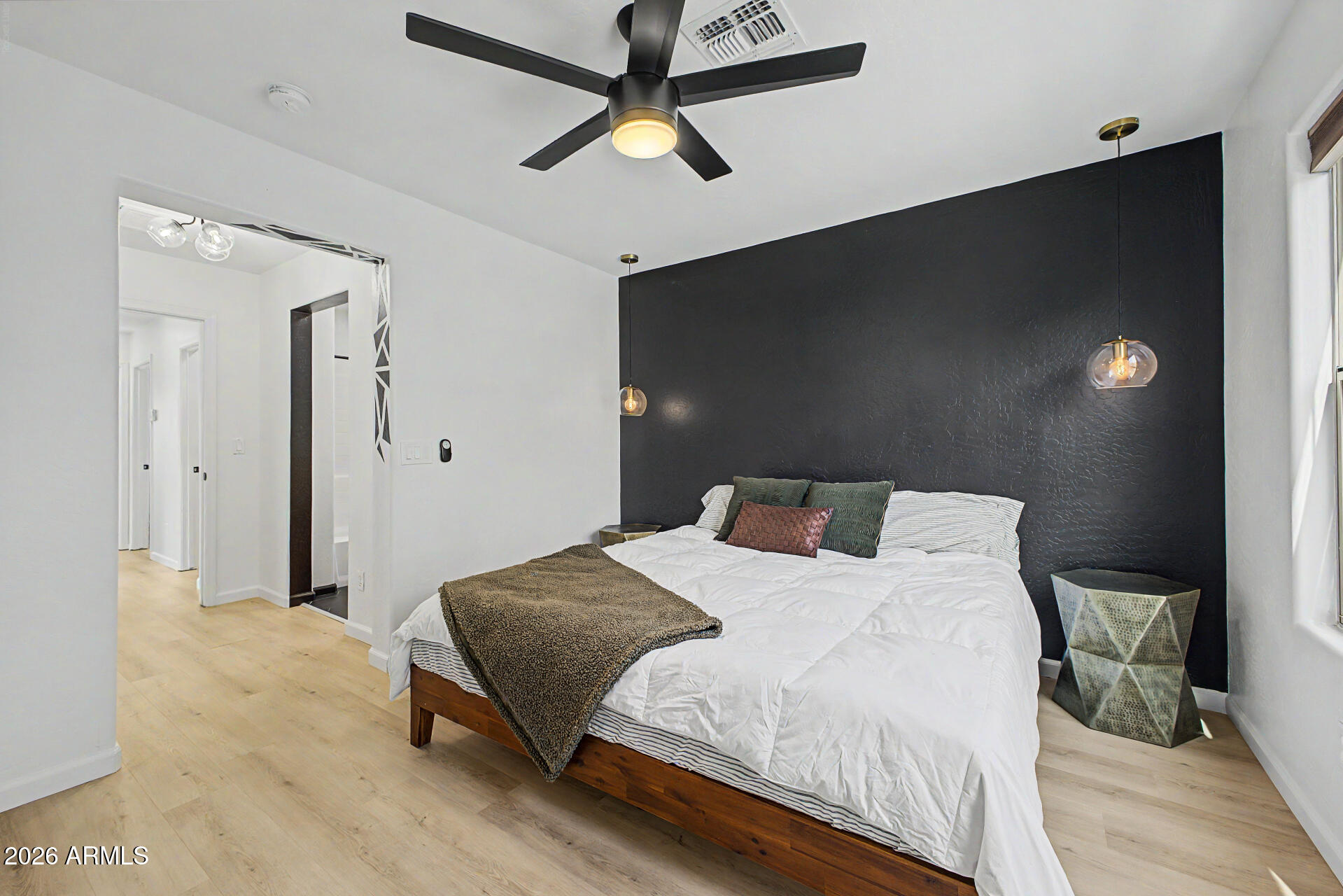 451 South Hawes Road, Unit 27 Mesa, AZ 85208 - Photo 12 of 27 a bedroom with a bed and a chandelier