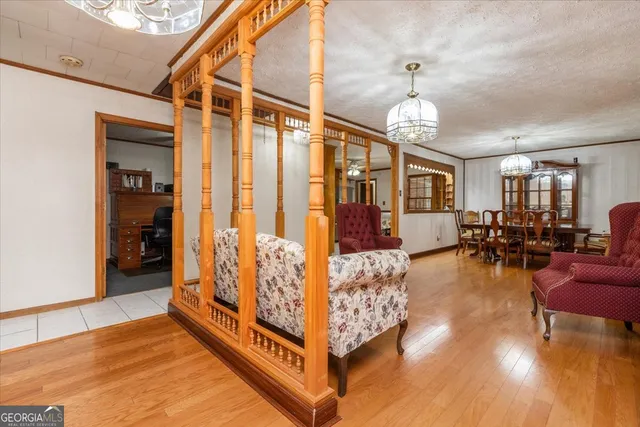 a living room with furniture a fireplace and a large window