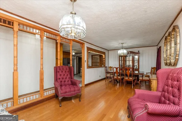 a living room with furniture a couch and a chandelier