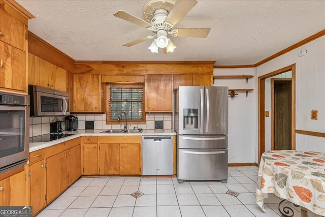 a spacious bedroom with a bed and a chandelier