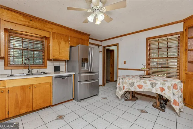 a kitchen with stainless steel appliances a sink and cabinets