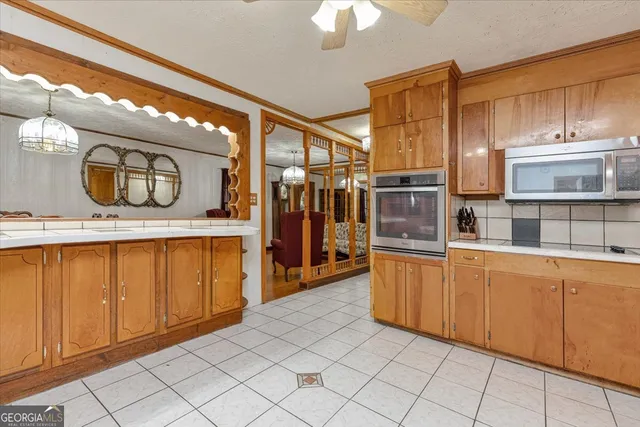 a kitchen with stainless steel appliances granite countertop a refrigerator a stove top oven a sink and dishwasher