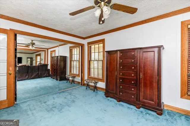 a bedroom with furniture and a large window